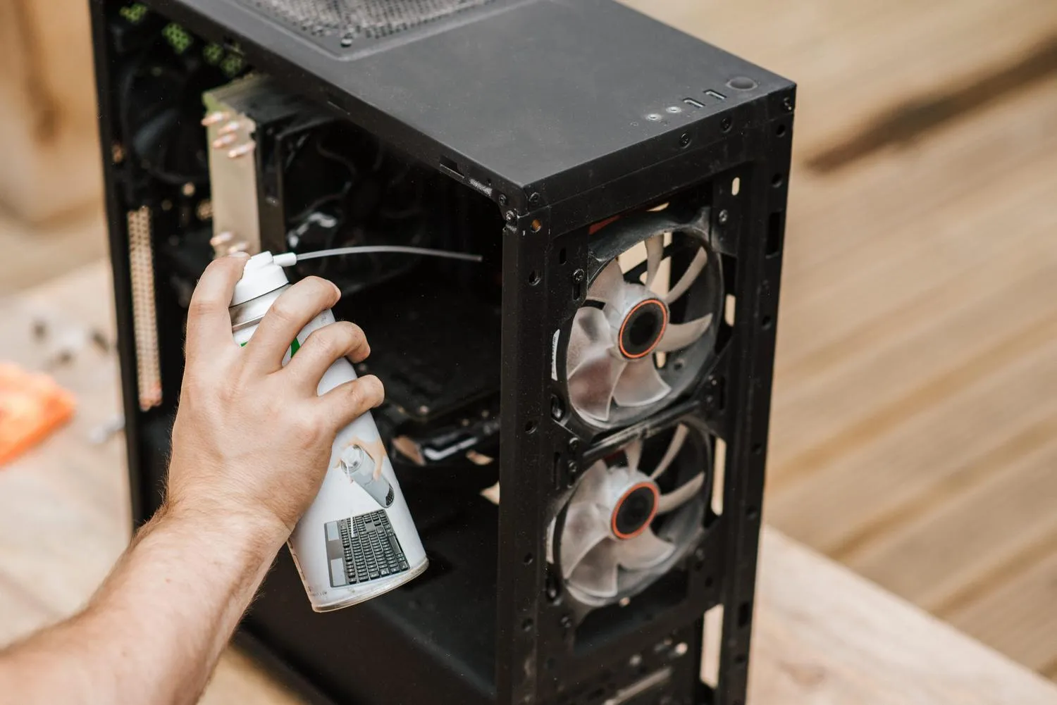 Using compressed air to remove dust from ventilation grilles
