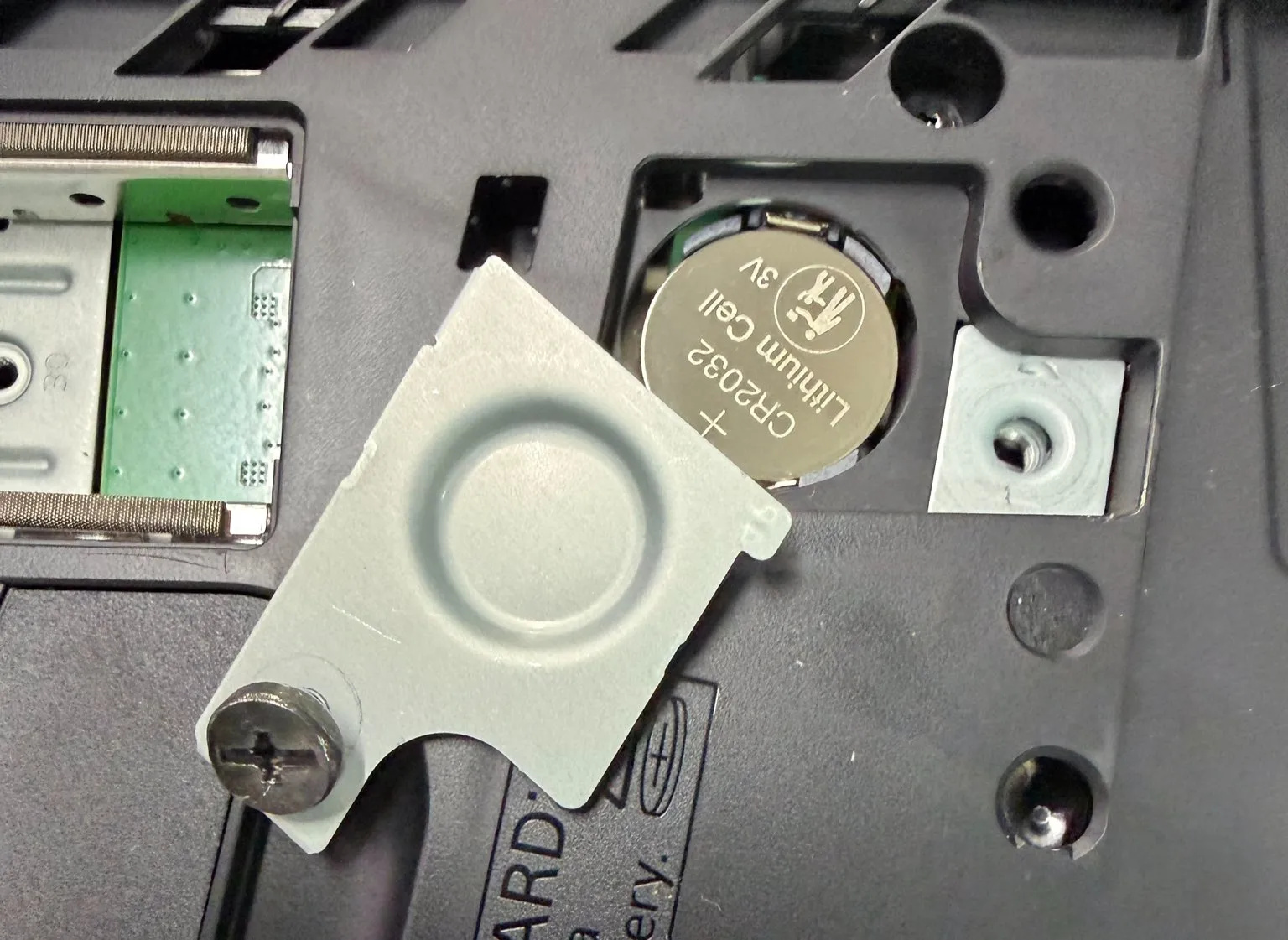 Close-up of the CR2032 battery seated in its holder on the EDM-051 board