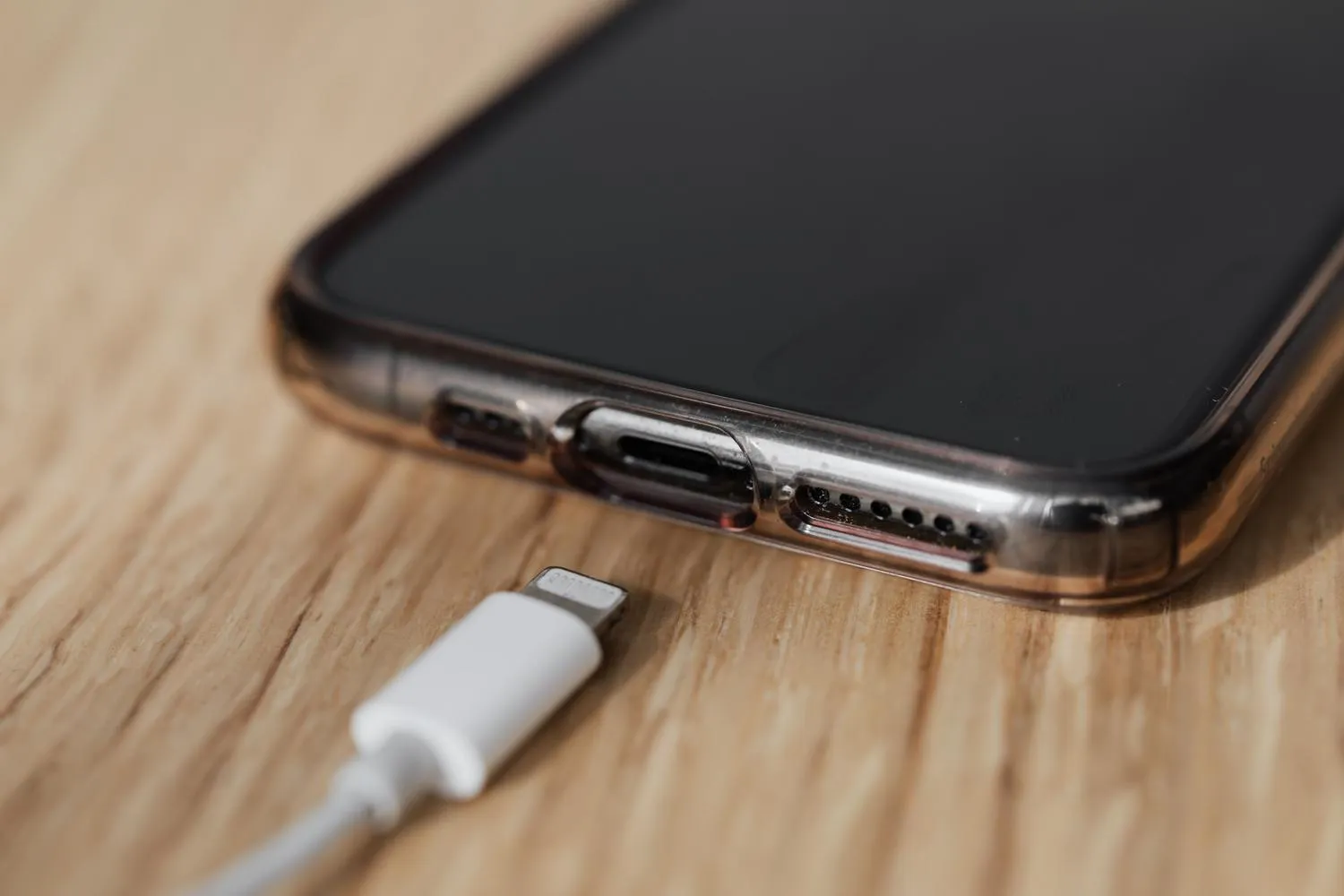 Primer plano del puerto de carga y el cable USB de un teléfono