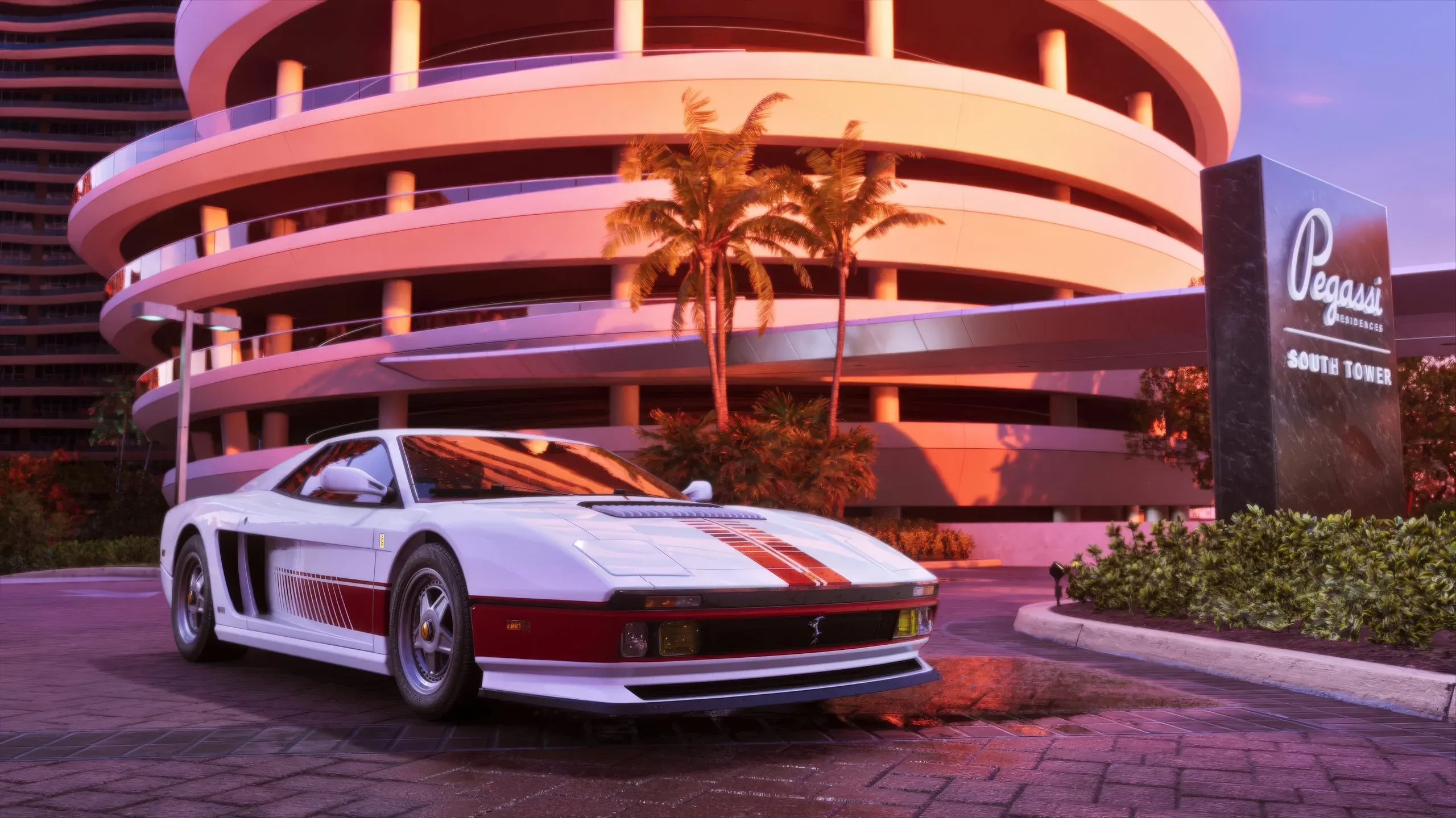 Un coche deportivo blanco con franjas rojas aparcado frente a las Pegassi Residences South Tower al atardecer