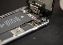 Persona manipulando un teléfono para sustituir su batería
