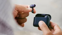 Cambridge Audio Melomania A100 SE wireless earbuds in blue held in a hand