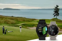 Two Garmin Approach S72 watches with fabric bands on a golf course by the sea, showing hole data on screen
