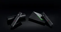The NVIDIA Shield TV Pro and Shield TV streamers next to their remotes, with the Netflix button visible.