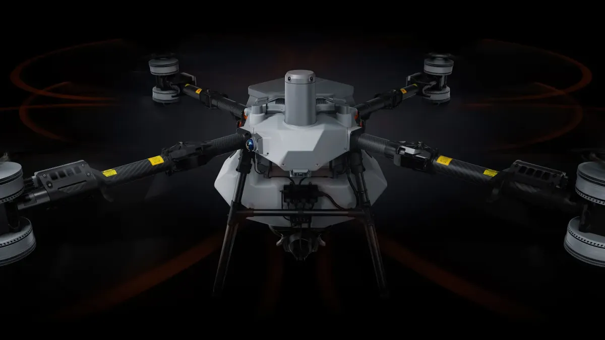 DJI Agras T100 agricultural drone seen from the front against a black background
