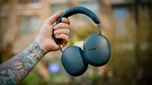Sonos Ace Ultra headphones in Blue Agave held outdoors
