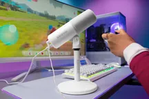 White Shure MV6 Gen 2 microphone on its desktop stand on a gaming desk