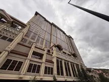Lucid Bots Sherpa cleaning drone spraying a facade high up using the HighLine pulley system