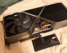 GeForce RTX 4090 Founders Edition with a detached block of aluminium heatsink fins exposing the heatpipes