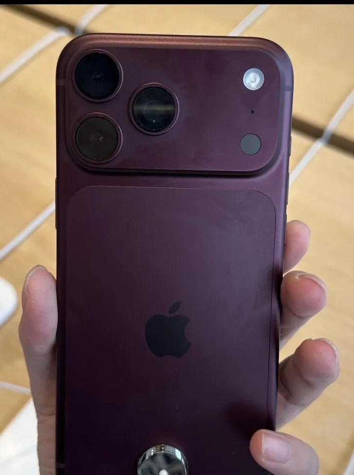 Back of a Burgundy iPhone 18 Pro Max held in the hand