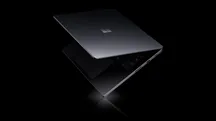 Dark Surface laptop photographed against a black background